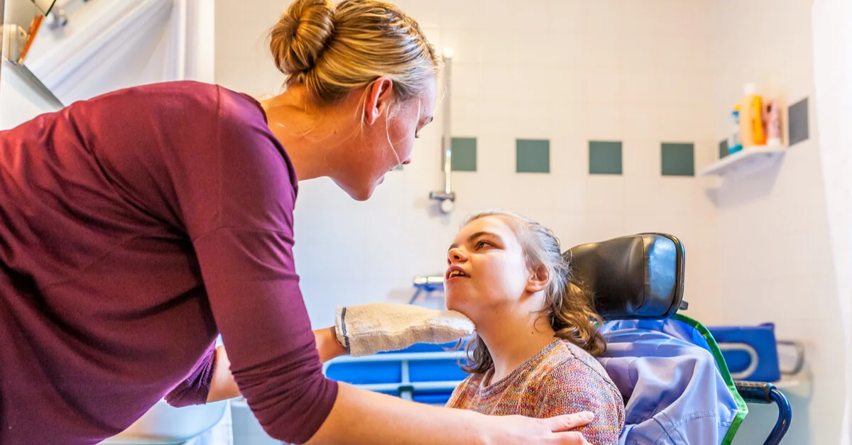 Pediatric nurse providing home nursing care for a child with cerebral palsy